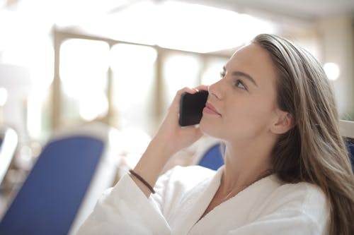 young woman talking on the phone and looking upwards